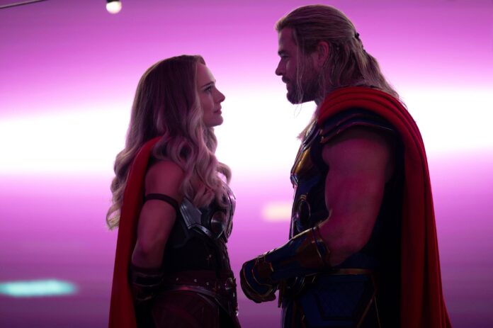 Mighty Thor and Thor look at each other under pink starlight in Thor Love and Thunder