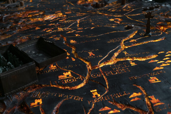 A map lit in fire on the wartable of Dragonstone